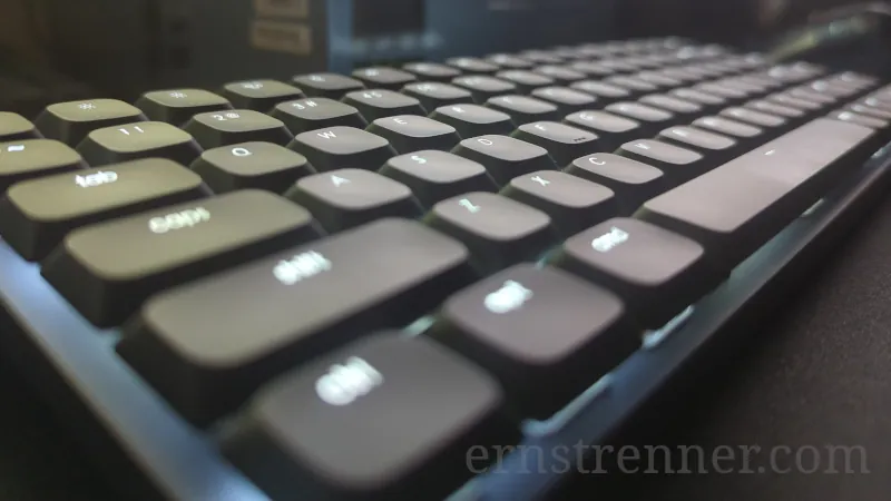 Photo of the Satechi SM1 Slim keyboard connected to a Mac Studio setup, highlighting the illuminated keycaps and sleek aluminum design.